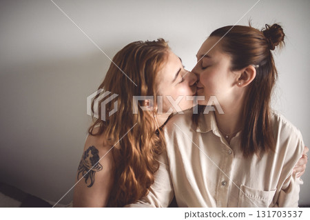 Happy couple cuddling on their bed at home. Romantic young LGBTQ Happy couple cuddling on their bed at home. Romantic young LGBTQ 131703537
