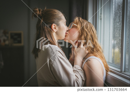 Happy couple cuddling on their bed at home. Romantic young LGBTQ Happy couple cuddling on their bed at home. Romantic young LGBTQ 131703664