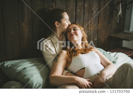 Happy couple cuddling on their bed at home. Romantic young LGBTQ Happy couple cuddling on their bed at home. Romantic young LGBTQ 131703700