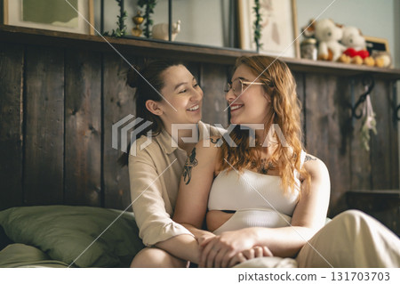 Happy couple cuddling on their bed at home. Romantic young LGBTQ Happy couple cuddling on their bed at home. Romantic young LGBTQ 131703703