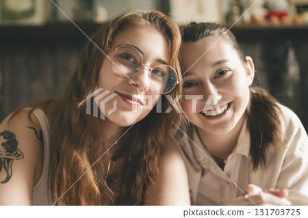 Happy couple cuddling on their bed at home. Romantic young LGBTQ Happy couple cuddling on their bed at home. Romantic young LGBTQ 131703725