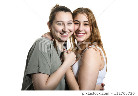 Happy lesbian couple on studio white background. 131703726