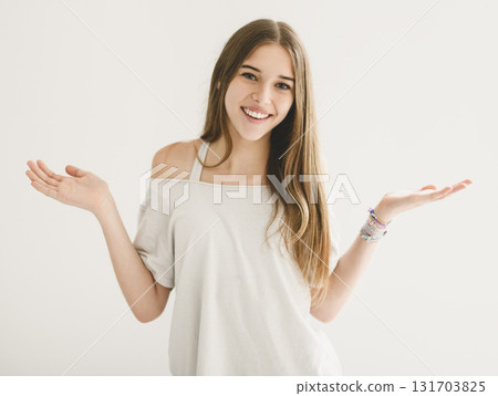 Portrait of teenage girl in casual t-shirt on light background in studio. 131703825