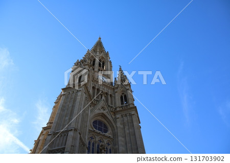 A beautiful European cathedral shining against the blue sky A beautiful European cathedral shining against the blue sky 131703902