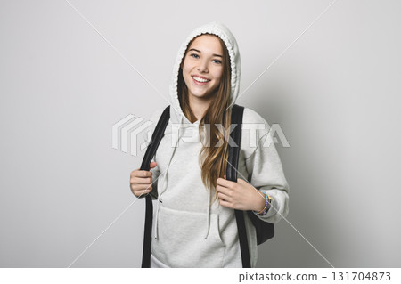 Portrait of teenage student girl in casual t-shirt on light background in studio. Portrait of teenage student girl in casual t-shirt on light background in studio. 131704873