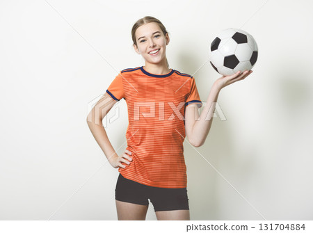 one caucasian young soccer player girl standing in studio gray background one caucasian young soccer player girl standing in studio gray background 131704884