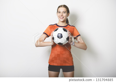 one caucasian young soccer player girl standing in studio gray background one caucasian young soccer player girl standing in studio gray background 131704885
