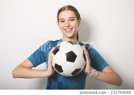 one caucasian young soccer player girl standing in studio gray background one caucasian young soccer player girl standing in studio gray background 131704899