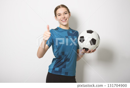 one caucasian young soccer player girl standing in studio gray background one caucasian young soccer player girl standing in studio gray background 131704900