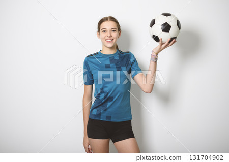 one caucasian young soccer player girl standing in studio gray background one caucasian young soccer player girl standing in studio gray background 131704902