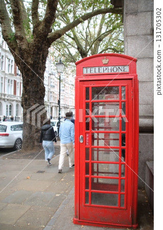 A red London telephone booth on a street corner 131705302