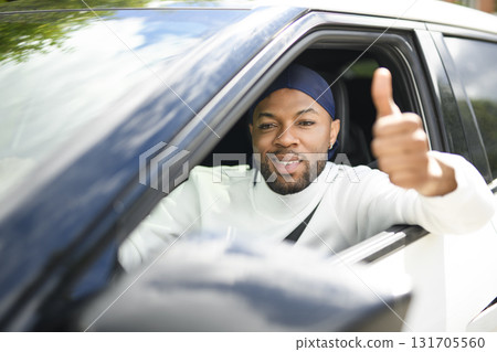 portrait of happy black american man driving car 131705560