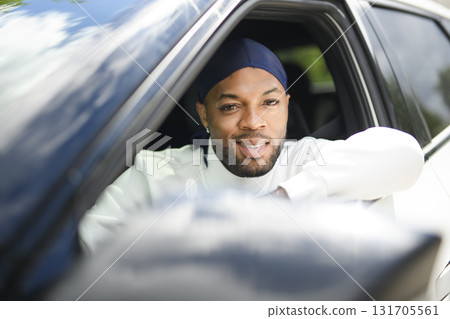 portrait of happy black american man driving car 131705561