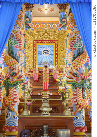 Gilded altar with left eye as the main religious symbol in Khao Dai religion, unique to Vietnam 131706266