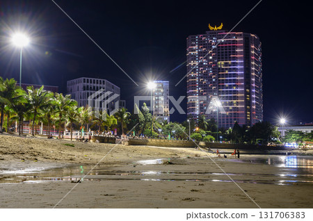 Night view of the skyscrapers of the Nha Trang city, Vietnam, from the bay of the sea at low tide Night view of the skyscrapers of the Nha Trang city, Vietnam, from the bay of the sea at low tide 131706383