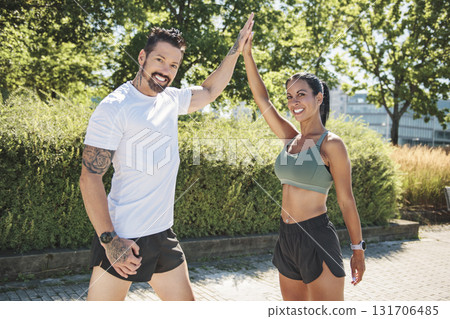 Young fitness couple running on a city on summer day 131706485