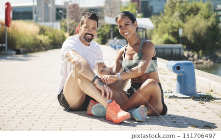 Young fitness couple sporty sit and watching watch on a city on summer day 131706497