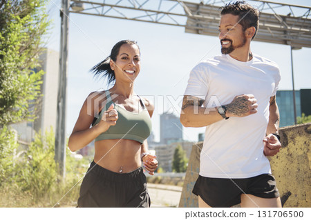 Young fitness couple running on a city on summer day Young fitness couple running on a city on summer day 131706500