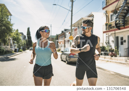 Young fitness couple running at the forest trail on a summer day 131706548