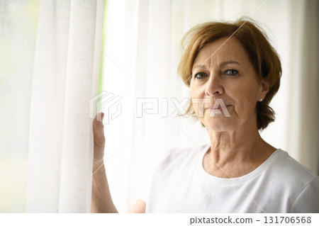 senior woman relax at home appartement close to window 131706568