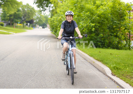 Happy mature cyclist woman enjoying healthy activity 131707517