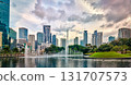 Panoramic view of Kuala Lumpur city center, Malaysia, with contemporary skyscrapers, KLCC park lake, fountains, lush greenery, dramatic evening sky, architectural landmarks. Reflection cityscape in 131707573
