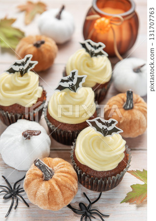 Halloween inviting celebration with themed cupcakes and pumpkins Halloween inviting celebration with themed cupcakes and pumpkins 131707763