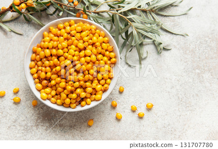 Sea buckthorn berries in bowl with branches Sea buckthorn berries in bowl with branches 131707780