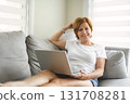 Happy modern European senior woman using laptop 131708281