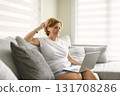 Happy modern European senior woman using laptop 131708286