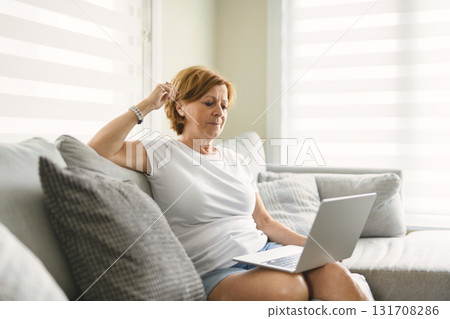 Happy modern European senior woman using laptop 131708286