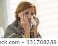 women with stress that suffer from allergies and close the nose with tissue paper. Because of having sneezing all the time 131708289