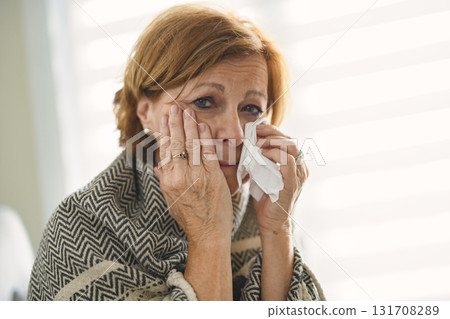 women with stress that suffer from allergies and close the nose with tissue paper. Because of having sneezing all the time 131708289