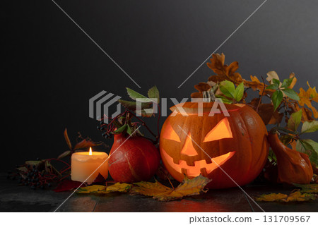 Halloween pumpkin head jack lantern with dried-up leaves. Halloween pumpkin head jack lantern with dried-up leaves. 131709567