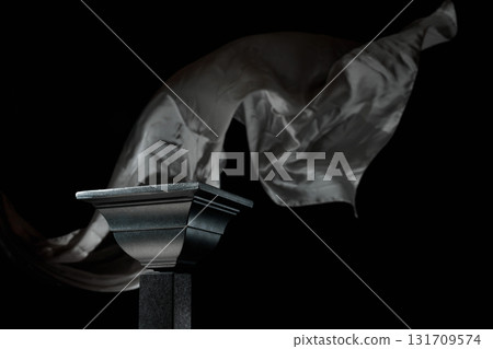 Luxury black podium on a background of waving grey atlas curtain. 131709574