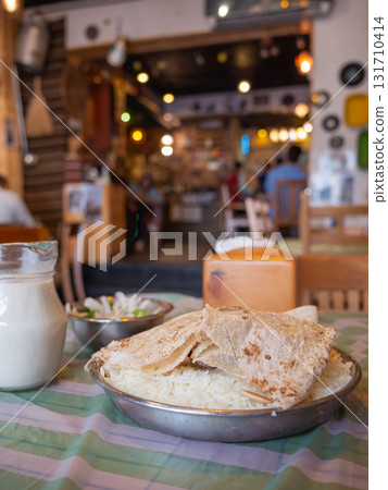[Jordan] Pots of national dishes mansaf and jamid lined up on a restaurant table in the capital Amman 131710414