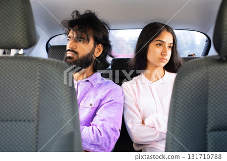 Indian couple sitting in silence in car, looking away from each other Indian couple sitting in silence in car, looking away from each other 131710788