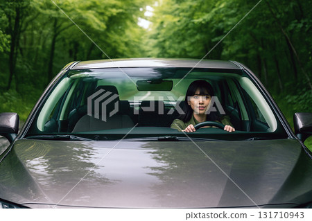 A woman driving through the greenery A woman driving through the greenery 131710943