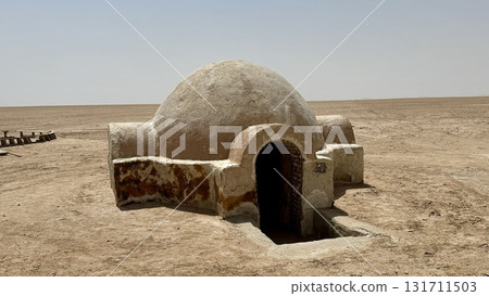 Dome-shaped desert building under clear skies 131711503