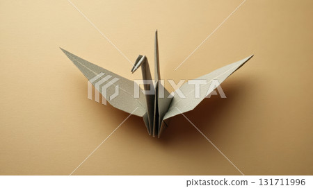 A minimalist origami crane on a beige background, a symbol of peace and Japanese paper art 131711996