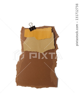 Torn piece of brown piece of paper with beige tape and black binder isolated on white background 131712738