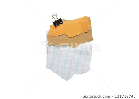 Torn piece of brown and yellow piece of paper with beige tape and black binder isolated on white background 131712743