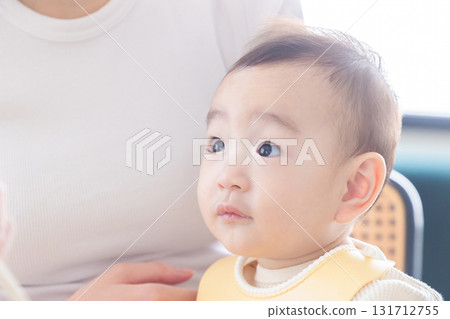 A baby hugged by a mother A baby hugged by a mother 131712755