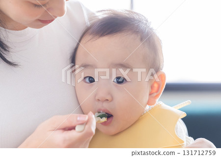Baby eating baby food Baby eating baby food 131712759