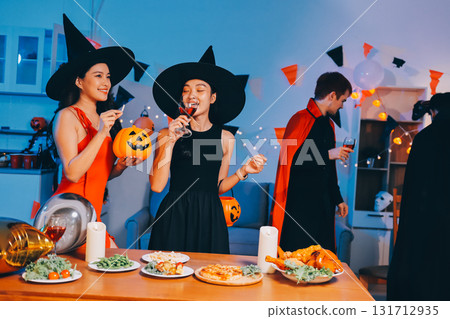 Joyful office Halloween party with coworkers in costumes, celebrating with drinks and laughter, fostering teamwork and festive spirit Joyful office Halloween party with coworkers in costumes, celebrating with drinks and laughter, fostering teamwork and festive spirit 131712935