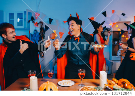 Joyful office Halloween party with coworkers in costumes, celebrating with drinks and laughter, fostering teamwork and festive spirit 131712944