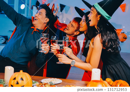 Joyful office Halloween party with coworkers in costumes, celebrating with drinks and laughter, fostering teamwork and festive spirit Joyful office Halloween party with coworkers in costumes, celebrating with drinks and laughter, fostering teamwork and festive spirit 131712953