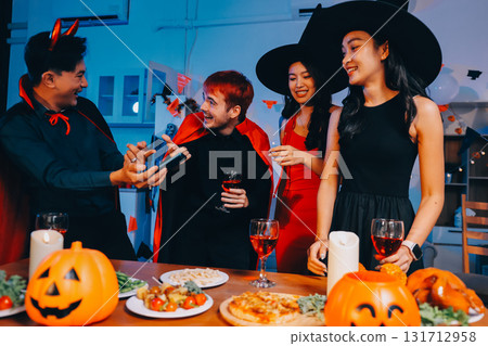 Joyful office Halloween party with coworkers in costumes, celebrating with drinks and laughter, fostering teamwork and festive spirit Joyful office Halloween party with coworkers in costumes, celebrating with drinks and laughter, fostering teamwork and festive spirit 131712958