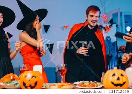 Joyful office Halloween party with coworkers in costumes, celebrating with drinks and laughter, fostering teamwork and festive spirit Joyful office Halloween party with coworkers in costumes, celebrating with drinks and laughter, fostering teamwork and festive spirit 131712959