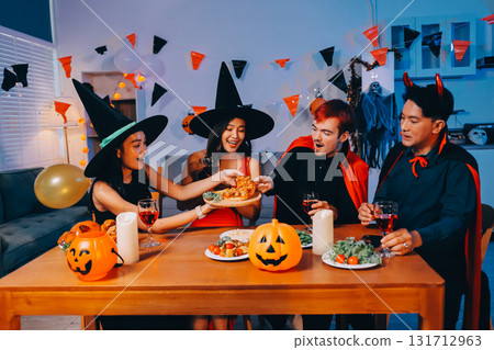 Joyful office Halloween party with coworkers in costumes, celebrating with drinks and laughter, fostering teamwork and festive spirit 131712963